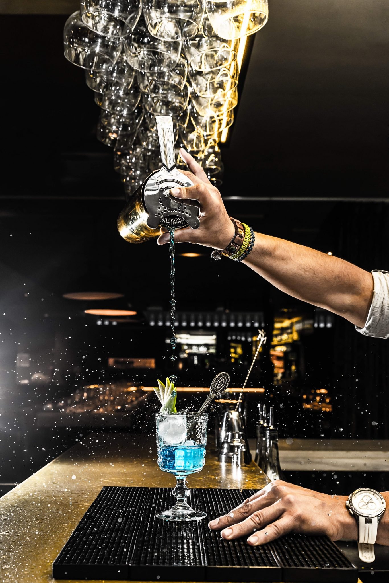 Expert barman is making cocktail at night club